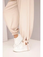 Dámske široké nohavice so zaväzovaním v spodnej časti béžové