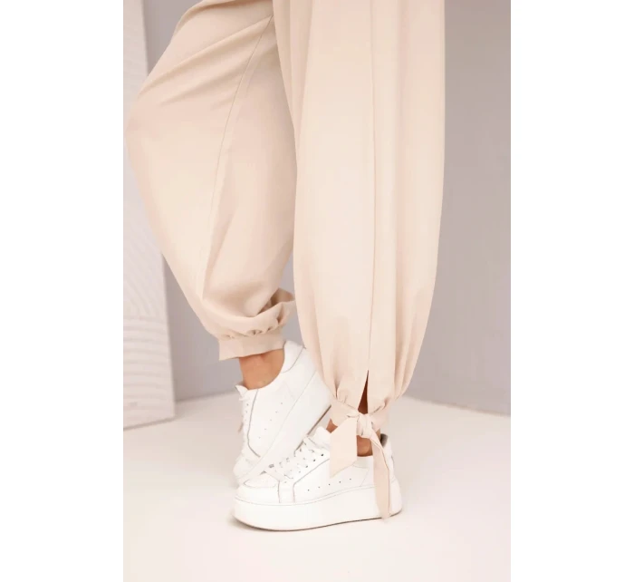 Dámske široké nohavice so zaväzovaním v spodnej časti béžové