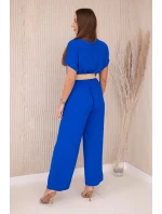 Kombinéza s ozdobným opaskom v páse chrpovo modrá Kombinéza s ozdobným opaskom v páse chrpovo modrá