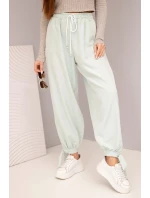 Dámske nohavice so širokými nohavicami a viazaním v spodnej časti tmavá mentolová