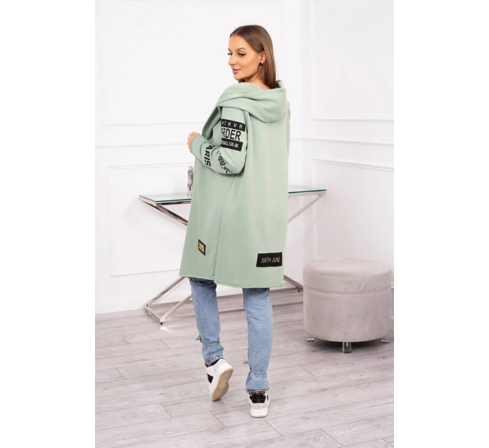 Pláštěnka světle mátové barvy s nápisy