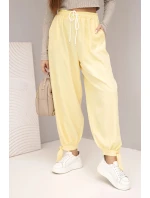 Dámske nohavice so širokými nohavicami a viazaním v spodnej časti žltej farby