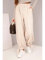Dámske široké nohavice so zaväzovaním v spodnej časti béžové