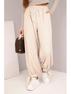 Dámske široké nohavice so zaväzovaním v spodnej časti béžové