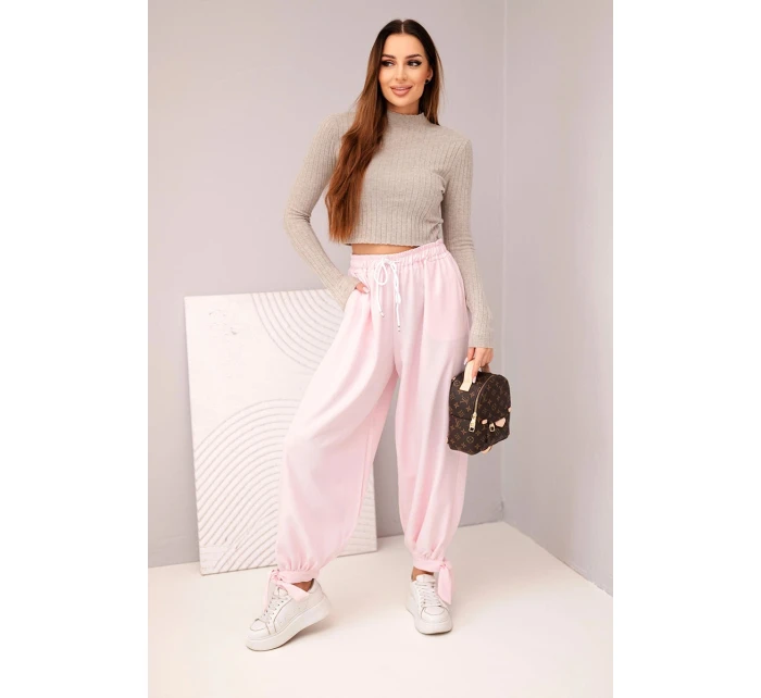 Dámske nohavice so širokými nohavicami a viazaním v spodnej časti candy pink
