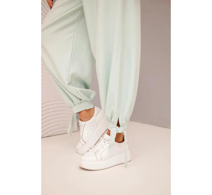 Dámske nohavice so širokými nohavicami a viazaním v spodnej časti tmavá mentolová