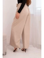 Dámske elegantné nohavice so širokými nohavicami a ozdobným kvetom béžovej farby