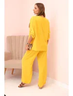 Dámska súprava s blúzkou s náhrdelníkom a širokými nohavicami žltá Dámska súprava s blúzkou s náhrdelníkom a širokými nohavicami žltá