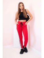 Dámske tepláky s opaskom a šnúrkou na stiahnutie červené