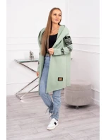 Pláštěnka světle mátové barvy s nápisy