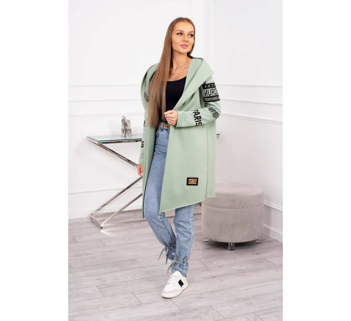 Pláštěnka světle mátové barvy s nápisy