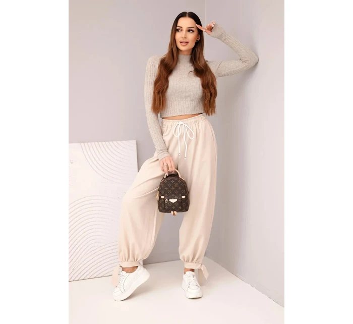 Dámske široké nohavice so zaväzovaním v spodnej časti béžové