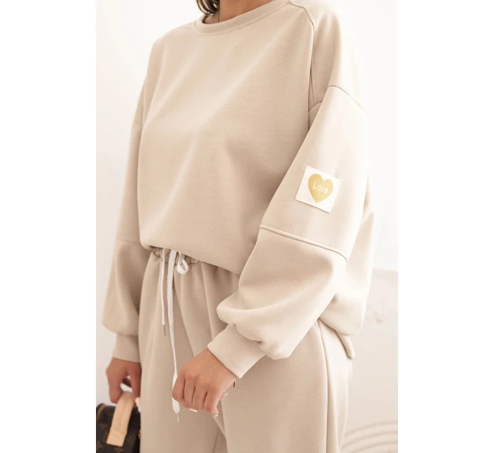 Dámska maslová súprava s voľnou mikinou a nohavicami LOVE beige Dámska maslová súprava s voľnou mikinou a nohavicami LOVE beige
